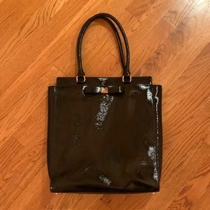 Kate Spade black patent leather handbag with black and white lining.